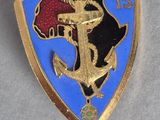 a close up of a gold and blue badge on a white surface