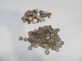 a pile of coins sitting on top of a white table