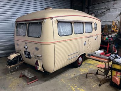 a small bus that is parked in a garage