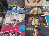 various vinyl records are on a table in a room