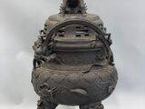 chinese bronze incense burner with dragon on top of it