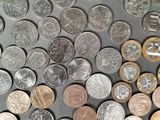 a lot of coins that are on the table