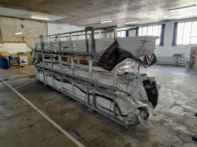 a truck that is parked in a building with a lot of sheets on the back