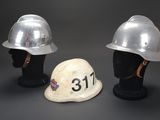 two helmets that are sitting next to each other on a mannequin head