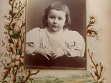 an old picture of a young girl in a picture frame
