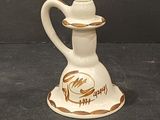 a small white vase with a brown and white design on it