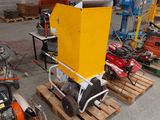 a yellow machine that is sitting on a pallet in a warehouse