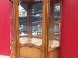 a wooden cabinet with a glass door on the side of it