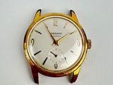 a gold watch with a white face on a white surface
