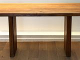 a wooden table sitting on top of a hard wood floor