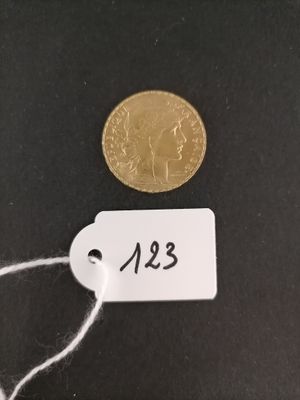 a close up of a coin on a string with a price tag