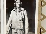 a black and white photo of a man in a pilot ' s uniform