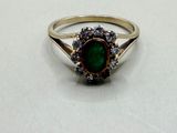an image of a ring with a green stone in it