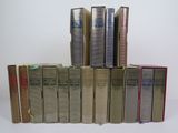 several books are stacked on top of each other on a table