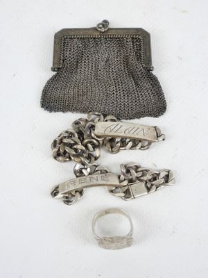 an image of a purse, chain, and ring on a white surface