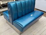 a blue couch that is sitting on a wooden table