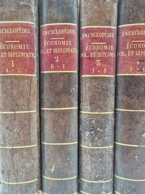 several old books are lined up in a row on a shelf