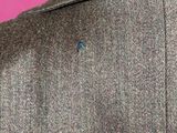 a close up of a man ' s jacket with a button on it