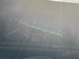 a car dashboard with the sun shining through the windshield