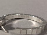 a close up of a silver ring with a diamond on it