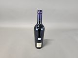 an empty bottle of wine sitting on top of a table