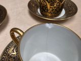 three cups and saucers sitting on a table