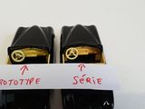 two pairs of black shoes with a label on them