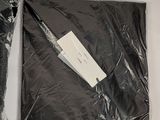 a bag of black plastic and a pair of scissors on a table