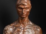 a bronze busturine of a man with no shirt on