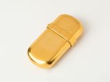 a gold lighter that is sitting on a white surface