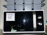 a microwave that is sitting on a shelf in the kitchen