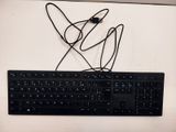 a black keyboard and a mouse on a white table