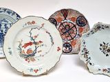 three plates with different designs on them sitting on a white surface