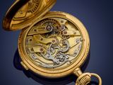 an image of a gold pocket watch with a chain on a blue background