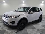 the white land rover is parked on a checkered tile floor