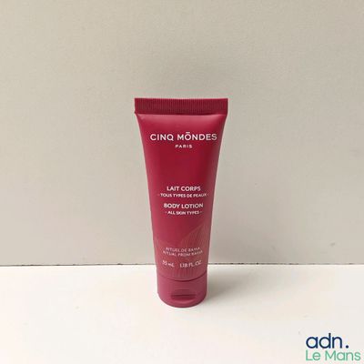 a close up of a tube of body lotion on a table