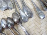 a lot of silver spoons and spoon spoons on a table