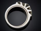 a close up of a silver ring on a black surface