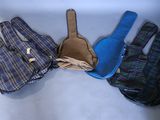 three pairs of gloves and a guitar case sitting on a table