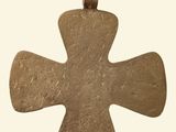 an image of a gold cross pendant on a white background