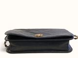 the small black bag has a gold clasp on the front