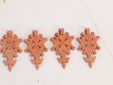 four pieces of clay are arranged in a row on a white surface