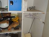 a cupboard with a microwave and a lot of clutter in it