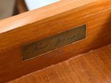 a close up of a wooden bench with a sign on it