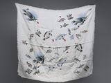 une image représentant un tissu blanc orné d'oiseaux, accroché à un mur