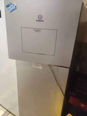 a picture of a white refrigerator with stickers on it