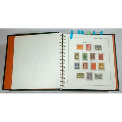 an open book with stamps on it sitting on top of a table