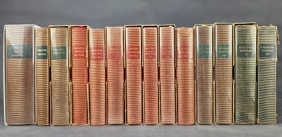 books are lined up in a row on a gray surface