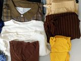 a lot of clothes that are laying out on a table