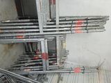 a lot of metal pipes and ladders in a room